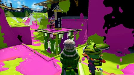 An Inkling rides the Tower as two opponents approach