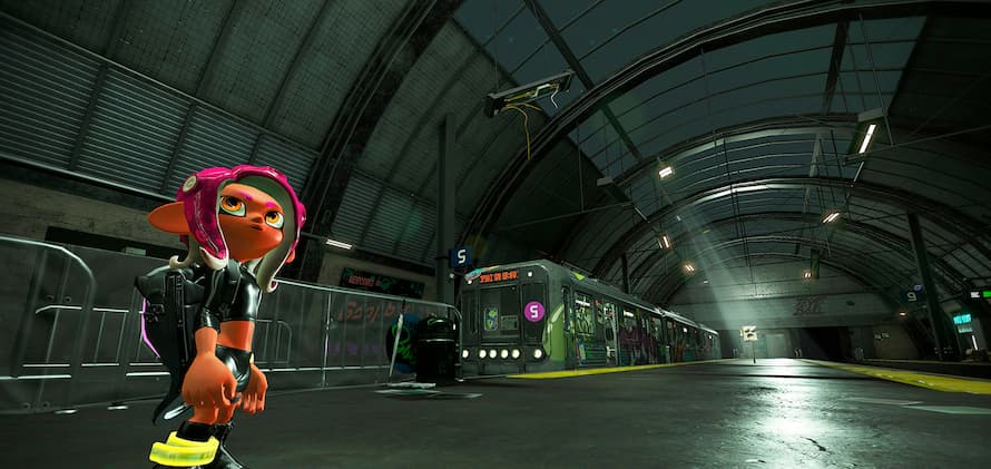 Agent 8 looks around the large Deepsea Metro terminal on a long platform where a mysterious light beams down on Telephone.